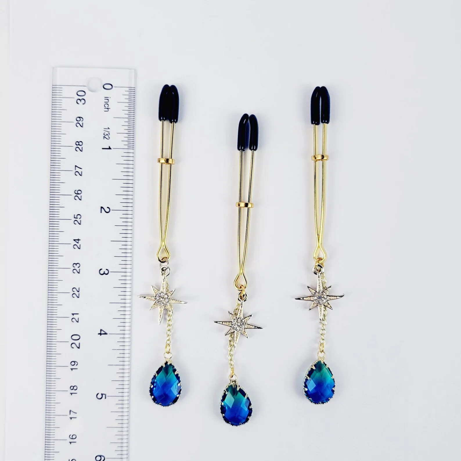 Gold Tweezer Clamp with Star and Blue Crystal